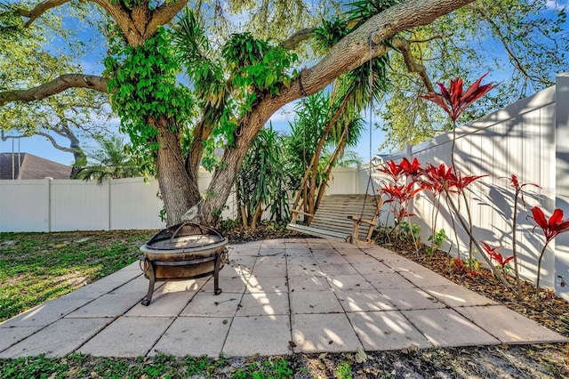 view of patio featuring an outdoor fire pit and a fenced backyard