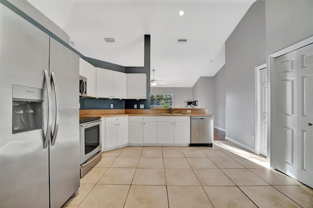 kitchen with white cabinetry, light tile patterned floors, visible vents, and appliances with stainless steel finishes