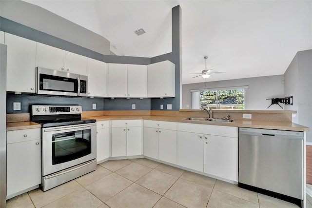 kitchen featuring white cabinets, appliances with stainless steel finishes, ceiling fan, and a sink