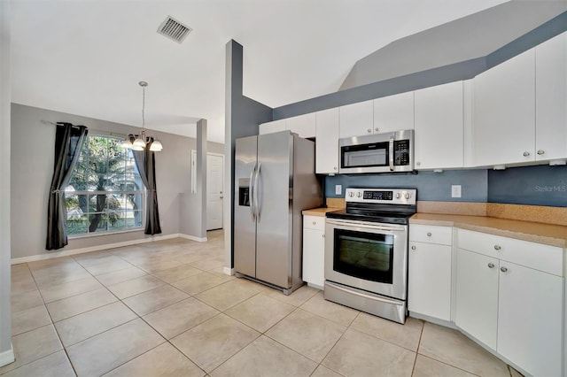 kitchen featuring visible vents, appliances with stainless steel finishes, light countertops, light tile patterned floors, and a chandelier