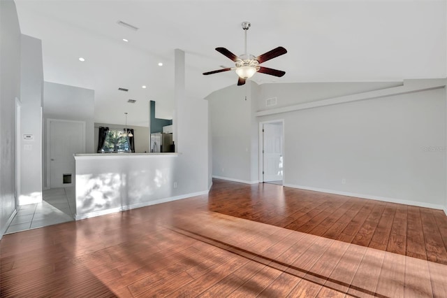 unfurnished living room featuring visible vents, baseboards, ceiling fan, hardwood / wood-style flooring, and high vaulted ceiling