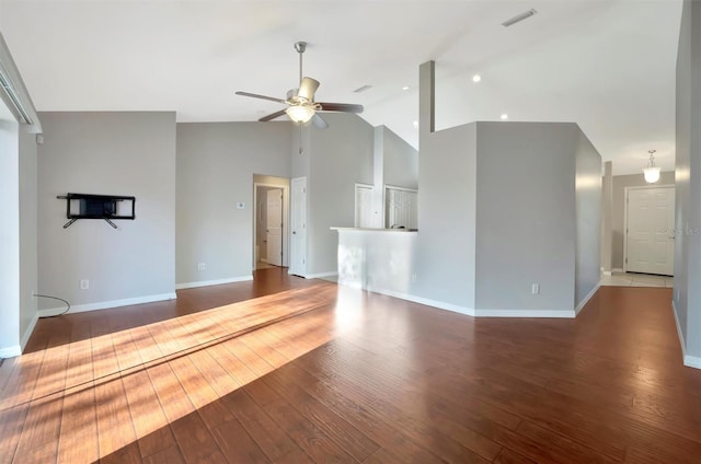 unfurnished living room with a ceiling fan, visible vents, wood-type flooring, and high vaulted ceiling