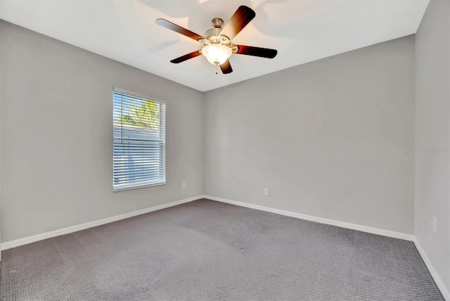 unfurnished room with a ceiling fan, baseboards, and carpet floors