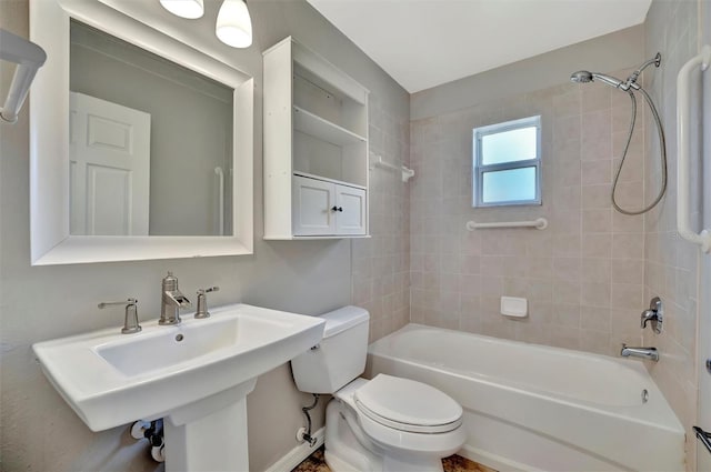 bathroom with a sink, shower / bath combination, and toilet