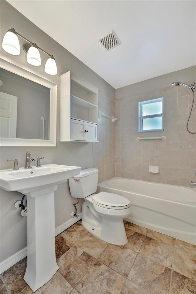 full bath featuring visible vents, baseboards, toilet, shower / bathing tub combination, and a sink