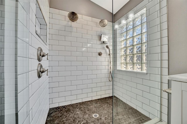 full bathroom with plenty of natural light and tiled shower