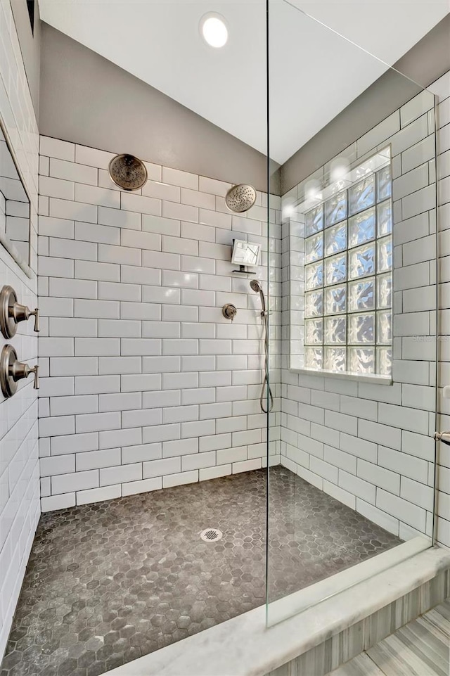 full bath with a walk in shower and vaulted ceiling