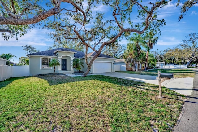 ranch-style house featuring fence, a front yard, stucco siding, driveway, and an attached garage