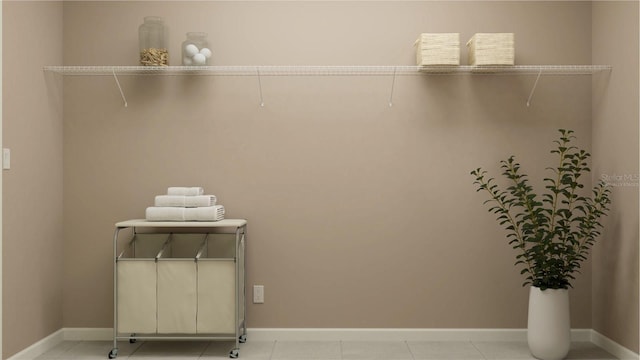 clothes washing area with baseboards