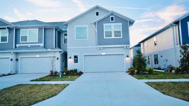 view of front of home featuring concrete driveway and a garage