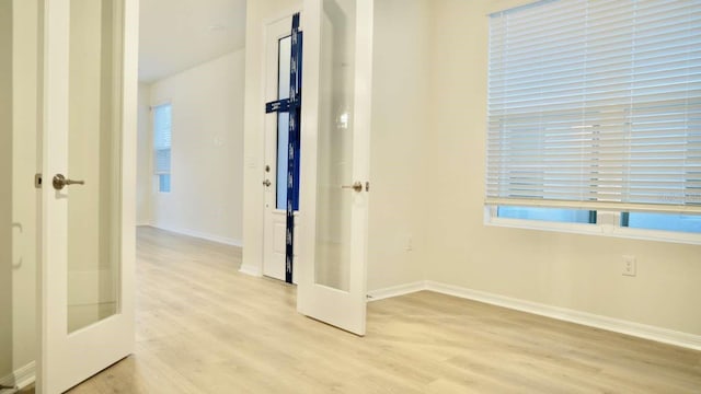 interior space with light wood-style flooring and baseboards