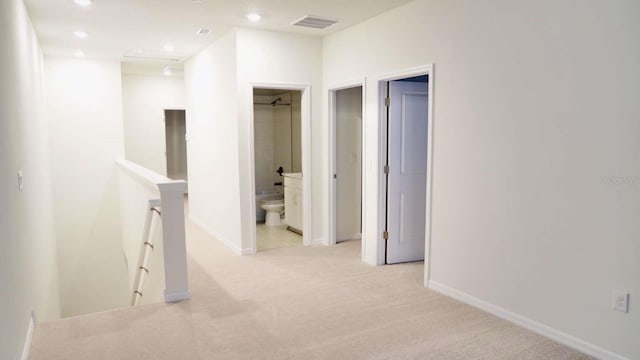 hall featuring visible vents, baseboards, recessed lighting, an upstairs landing, and light colored carpet