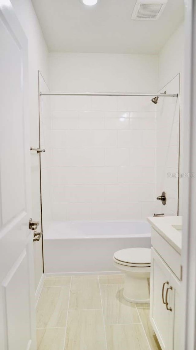 bathroom featuring visible vents, toilet, shower / bath combination, and vanity