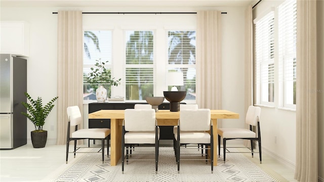 dining space featuring a wealth of natural light and baseboards