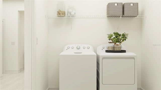 washroom with independent washer and dryer and laundry area