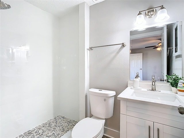 bathroom featuring vanity, toilet, and a ceiling fan