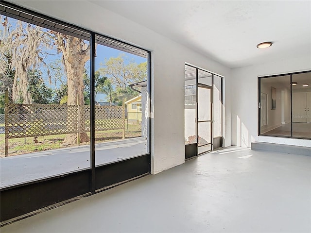 unfurnished room with finished concrete floors