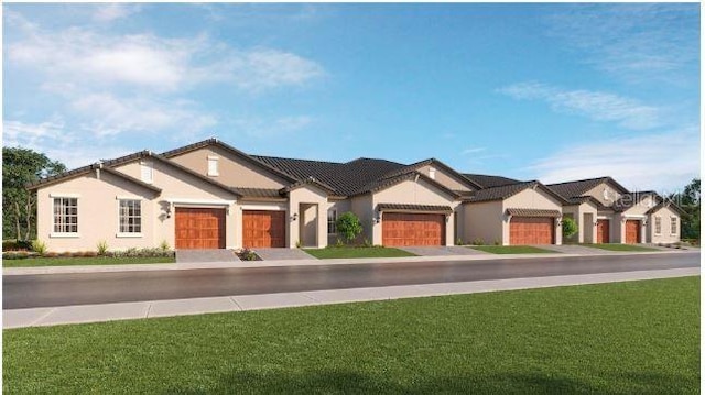 view of front of property with a front yard, an attached garage, and stucco siding