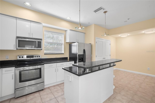 kitchen with dark countertops, visible vents, white cabinets, and stainless steel appliances