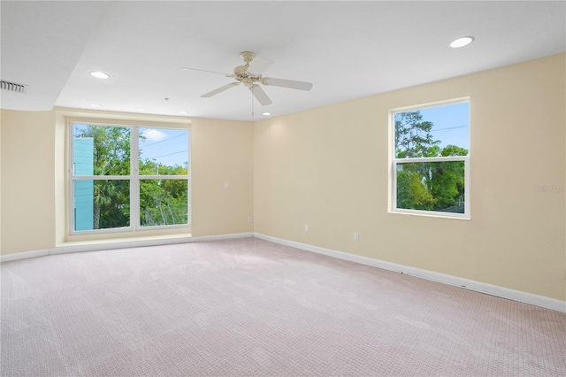 unfurnished room featuring visible vents, baseboards, recessed lighting, ceiling fan, and light colored carpet