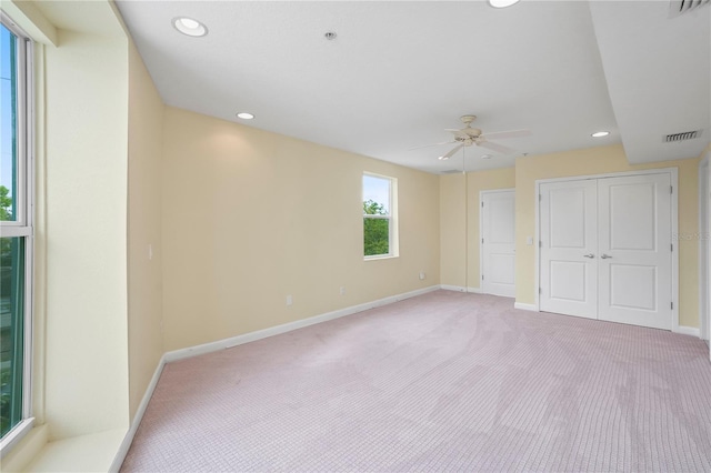 spare room with light carpet, recessed lighting, baseboards, and ceiling fan