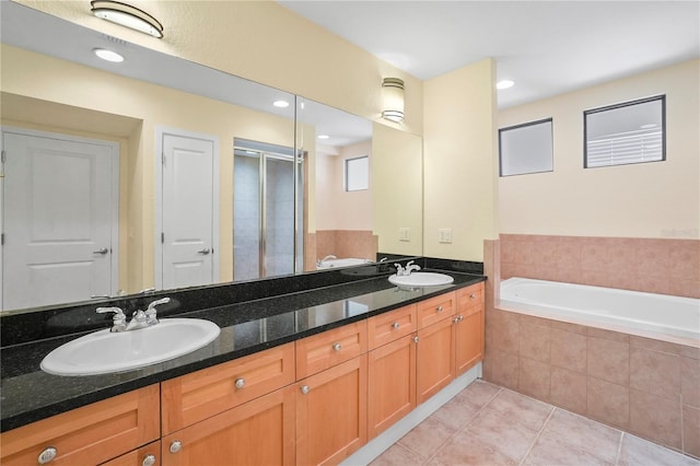 full bathroom with tile patterned flooring, a shower stall, a bath, and a sink