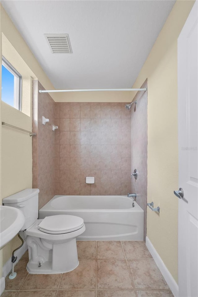 bathroom featuring tile patterned floors, visible vents, toilet, and bathing tub / shower combination