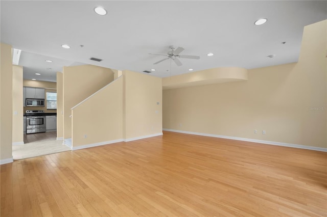 unfurnished living room with recessed lighting, a ceiling fan, visible vents, and light wood-type flooring