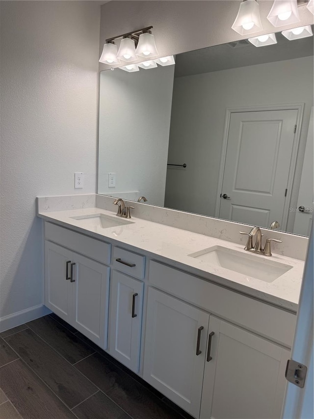10578 Gable Dig Loop, San Antonio, FL 33576 - bathroom with double vanity, baseboards, and a sink