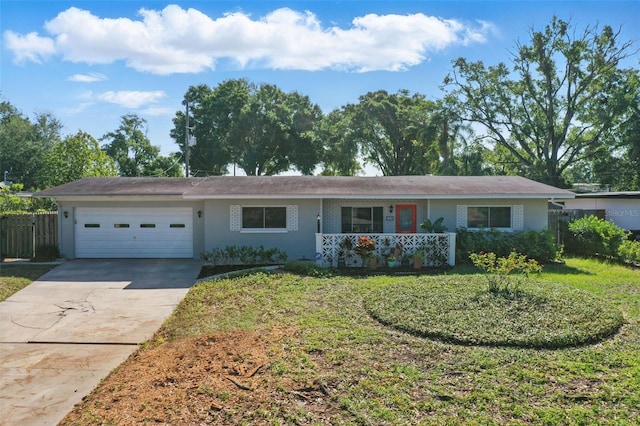 1005 Catalpa Ln, Orlando, FL 32806 - ranch-style home with an attached garage, fence, driveway, and a front lawn