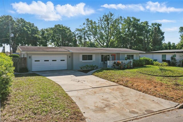 1005 Catalpa Ln, Orlando, FL 32806 - ranch-style house featuring an attached garage, driveway, and a front lawn