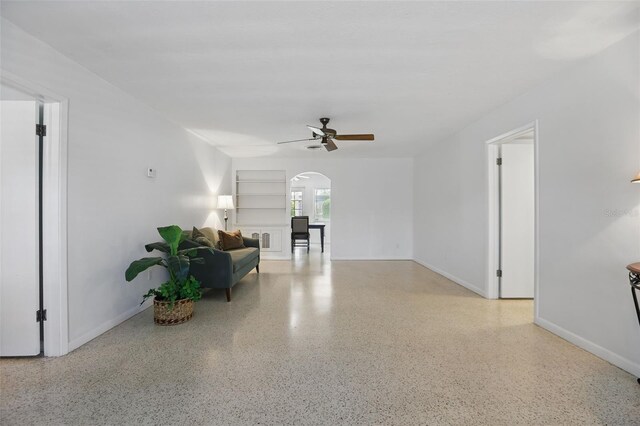 1005 Catalpa Ln, Orlando, FL 32806 - interior space featuring built in features, ceiling fan, arched walkways, speckled floor, and baseboards