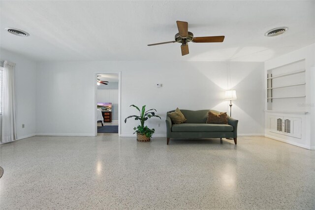 1005 Catalpa Ln, Orlando, FL 32806 - living area with speckled floor, a ceiling fan, and visible vents