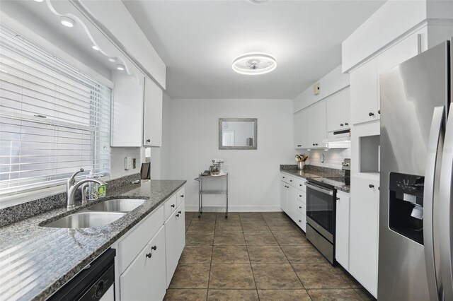 1005 Catalpa Ln, Orlando, FL 32806 - kitchen with appliances with stainless steel finishes, a sink, white cabinets, and under cabinet range hood