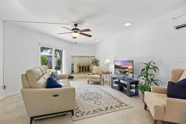 1005 Catalpa Ln, Orlando, FL 32806 - living room featuring ceiling fan, a wall unit AC, speckled floor, a glass covered fireplace, and baseboards