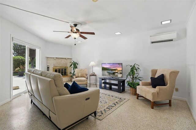 1005 Catalpa Ln, Orlando, FL 32806 - living room with baseboards, ceiling fan, speckled floor, a glass covered fireplace, and a wall unit AC