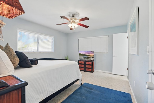 1005 Catalpa Ln, Orlando, FL 32806 - bedroom with speckled floor, baseboards, and a ceiling fan