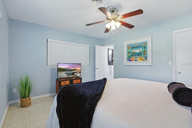 1005 Catalpa Ln, Orlando, FL 32806 - bedroom featuring speckled floor, baseboards, and a ceiling fan