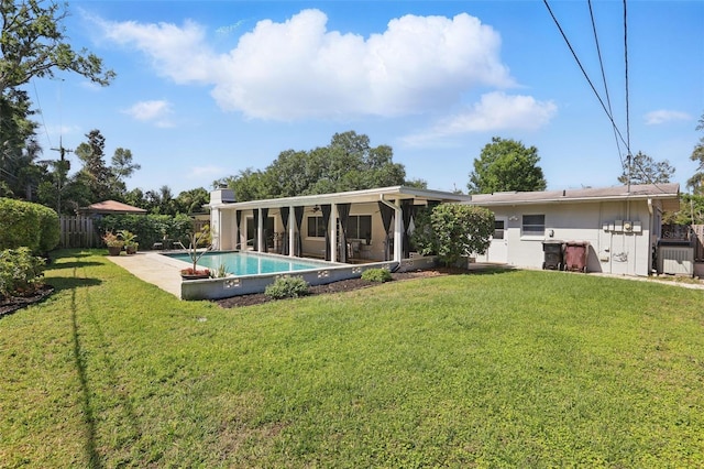1005 Catalpa Ln, Orlando, FL 32806 - back of property with a fenced in pool, a yard, a fenced backyard, and a sunroom