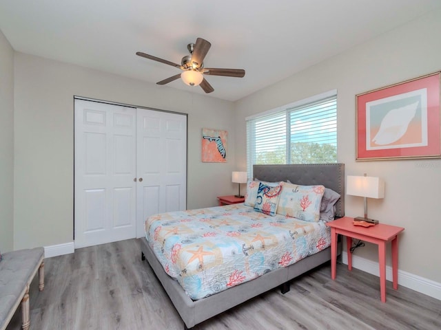 bedroom featuring a closet, baseboards, and wood finished floors