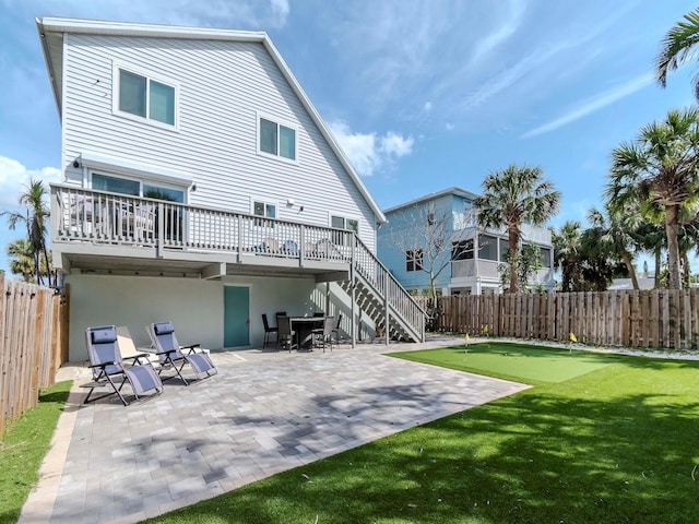 back of property with stairs, a patio area, and a fenced backyard