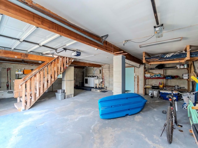 garage with washer / dryer and a garage door opener