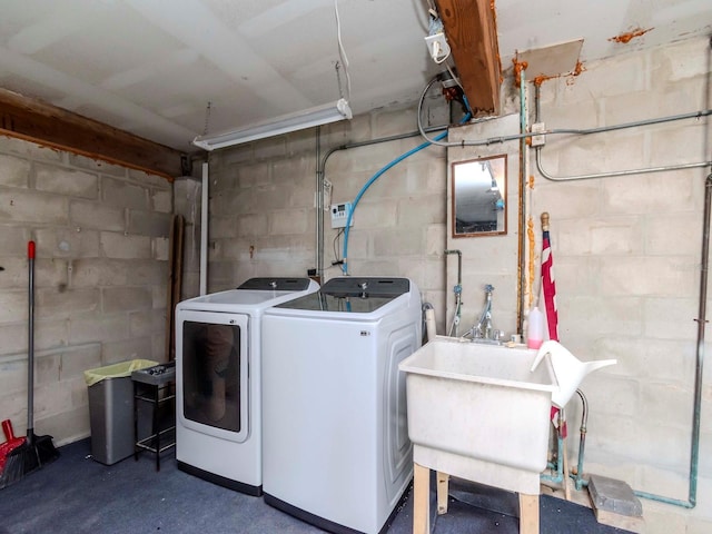 laundry room featuring laundry area, a sink, and separate washer and dryer