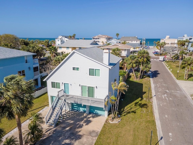 birds eye view of property with a water view and a residential view