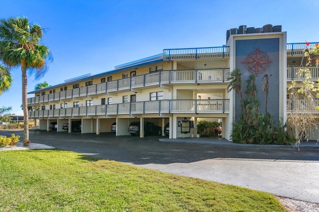 view of building exterior with covered parking