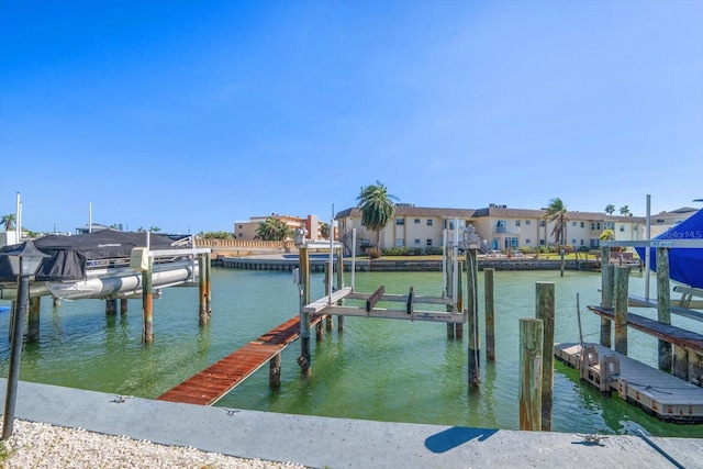 view of dock with a residential view, a water view, and boat lift