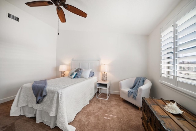 carpeted bedroom with baseboards, visible vents, and ceiling fan