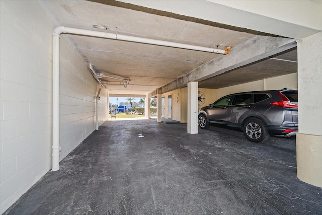 garage with concrete block wall