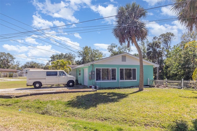 view of side of home featuring a yard and fence