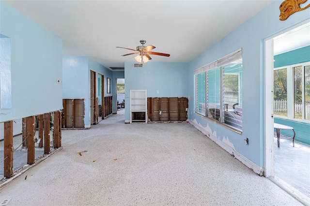 interior space with visible vents and a ceiling fan